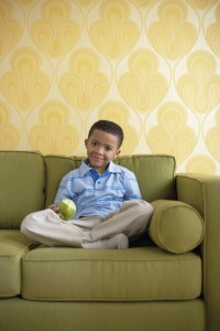 Satisfied Young Boy with a Green Apple --- Image by © Royalty-Free/Corbis