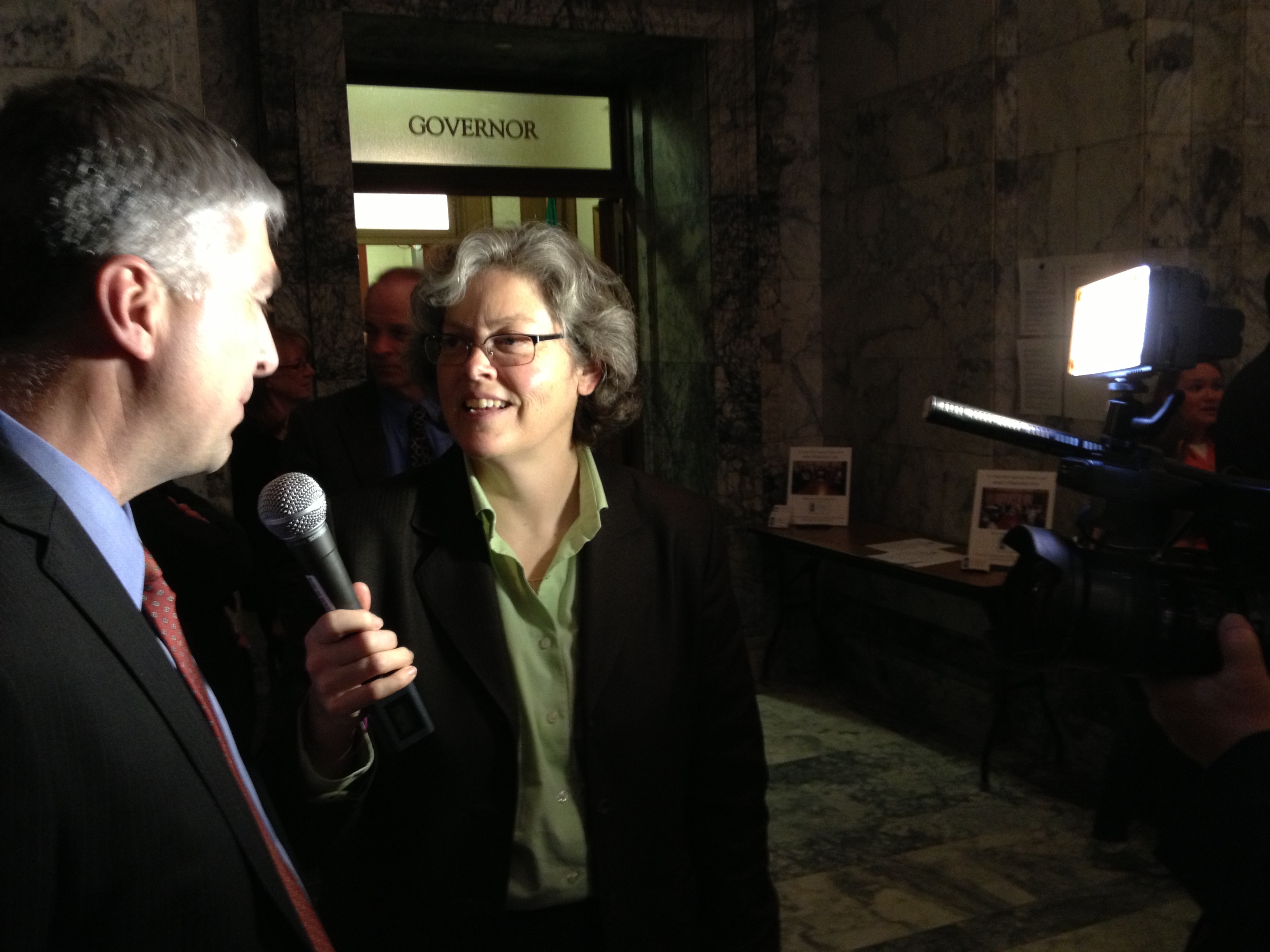 Rep. Laurie Jinkins interviews prosecutor Tom McBride at Gov. Jay Inslee's bill signing event. Photo by Andy McVicar.