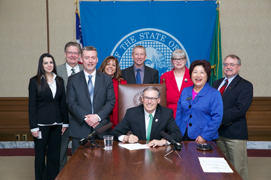 Governor Jay Inslee signs House Bill No. 2140.Relating to credit unions' mergers. March 12, 2014. Aaron Barna