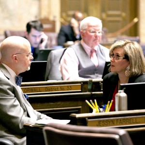 Rep. Sharon Wylie talking with her seatmate, Rep. Jim Moeller, on the House floor.