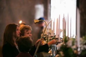 Reps. Judy Clibborn and Tana Senn lighting a candle at the memorial for elected officials who have passed away in the past two years. Clibborn and Senn honored former state Rep. Ida Ballasiotes.