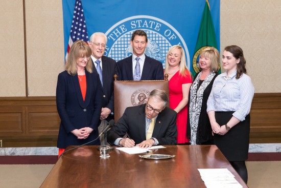Rep. Patty Kuderer (D-Clyde Hill) looks on as Governor Inslee signs HB 2425. Credit: Washington LSS