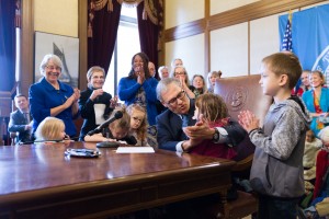 Governor Jay Inslee signs the executive order.