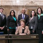 Rep. John Lovick (D-Mill Creek, center) on the floor of the House of Representatives with Rep. Mike Pellicciotti, Rep. Krstine Reeves, Transportation Chair Rep. Judy Clibborn (seated), Rep. Shelley Kloba and Rep. Christine Kilduff.