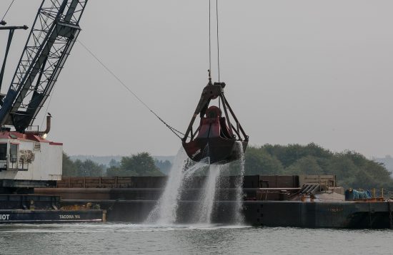 Lawmakers took a tour of the Port of Grays Harbor, including a look at this dredging crane at work to deepen the channel. Photo by Linda Barnfather, courtesy of the Washington state Legislature.