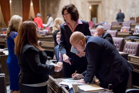 Rep. Kilduff speaking with Republican lawmakers on floor of House