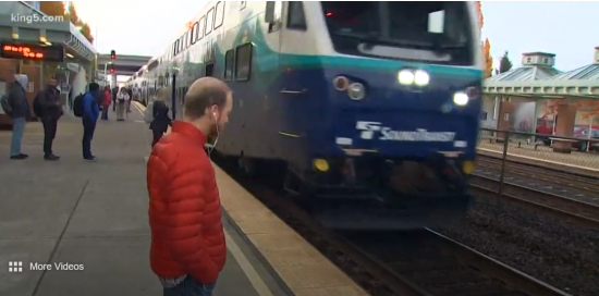 Man waits as Sounder train arrives at station