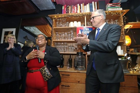 Gov. Jay Inslee applauds WA Fairness campaign manager Cherika Carter at an election-night party for supporters of Referendum 88 in Seattle.