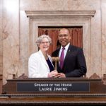 Speaker Laurie Jinkins (D-Tacoma) Deputy Speaker Pro Tempore John Lovick (D-Mill Creek) at the House rostrum jointly holding gavel.