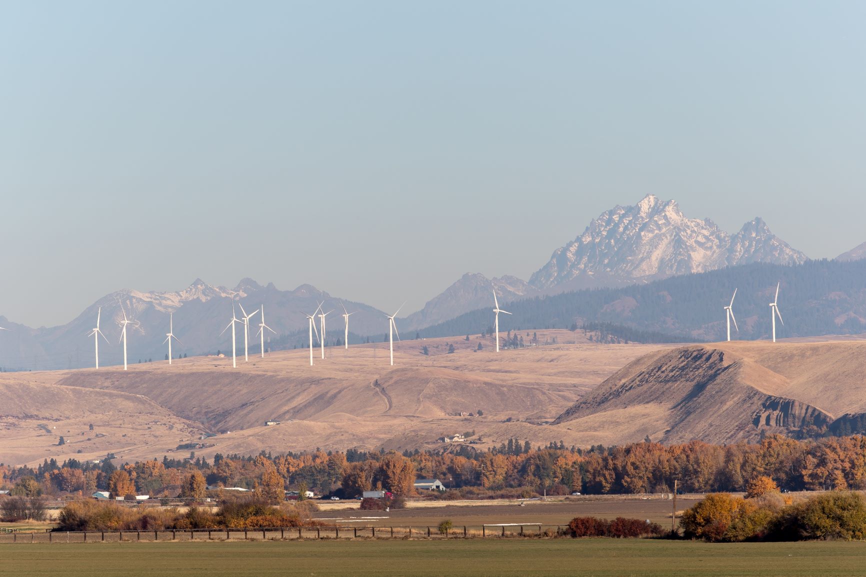 View of Mt. Stuart from Ellensburg, in the foreground are farms and windmills