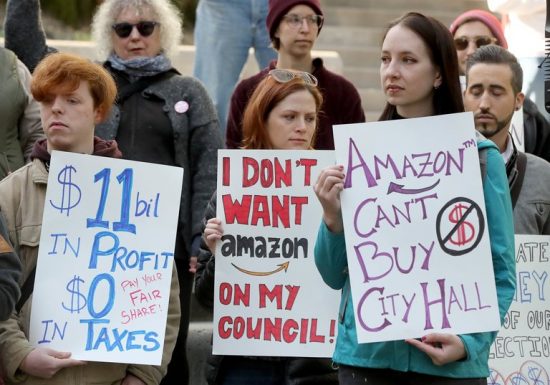 Demonstrators protest Amazon's large contributions to Seattle City Council elections. 