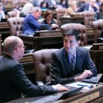 Rep. ALex Ramel at his desk on the floor