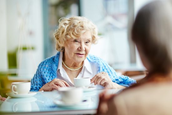 Retiree talking with friends over coffee