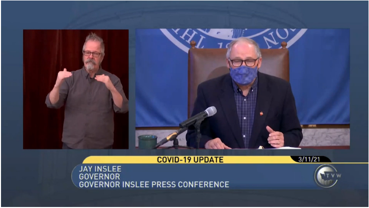 ASL interpreter on the left with Gov Inslee on the right at a press conference on TVW 