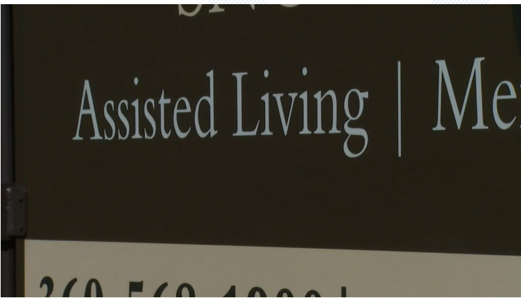 A brown sign that says Assisted Living