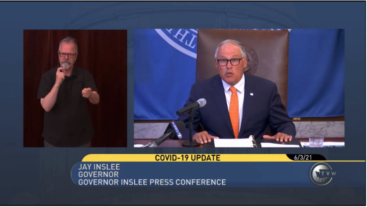 A video shot at a press conference of an ASL interpreter on the left and Gov. Inslee on the right announcing Washington state's vaccine lottery incentive. 