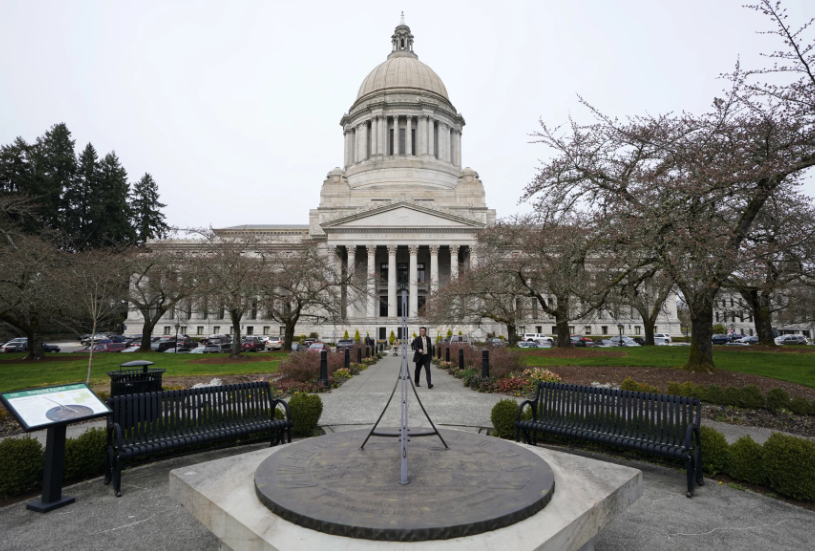 FILE - The sun dial near the Legislative Building is shown under cloudy skies, March 10, 2022, at the state Capitol in Olympia, Wash. An effort to balance what is considered the nation's most regressive state tax code comes before the Washington Supreme Court on Thursday, Jan. 26, 2023, in a case that could overturn a prohibition on income taxes that dates to the 1930s. 
