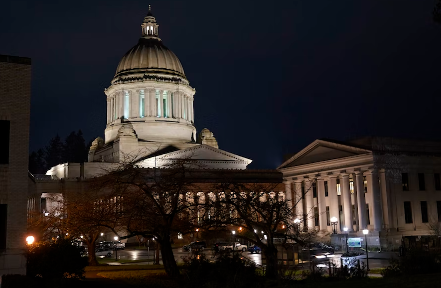 The Legislative Building, left, stands at night on Thursday, Nov. 12, 2020, at the Capitol in Olympia, Wash.