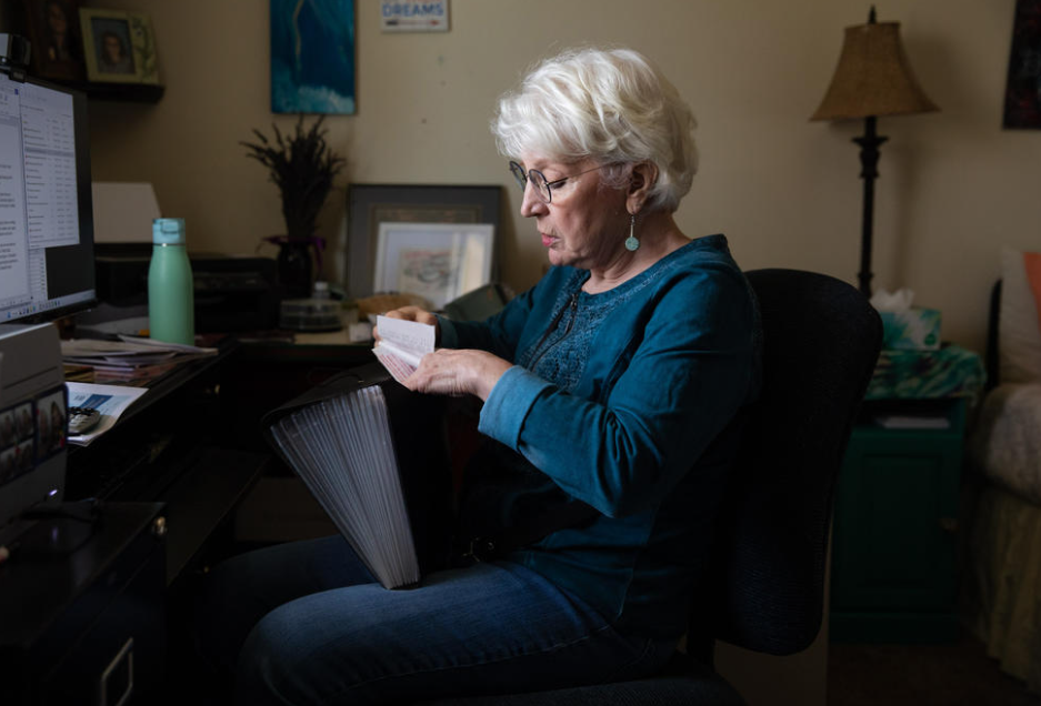 Patricia Divine Wilder goes through the receipts she uses to calculate her monthly expenses, on Thursday, Jan. 26, 2023, in Walla Walla. Lately she’s had to shop at Walmart for groceries and turn down restaurant lunches with friends to ensure she has enough to pay her rent.