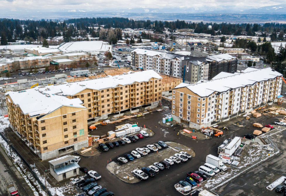 Builders work on the Four Corners Apartments on Beverly Lane near Evergreen and 79th Place SE on March 1 in Everett, Washington. DevCo, the real estate company building affordable housing, is receiving a $1 million grant from the city of Everett.