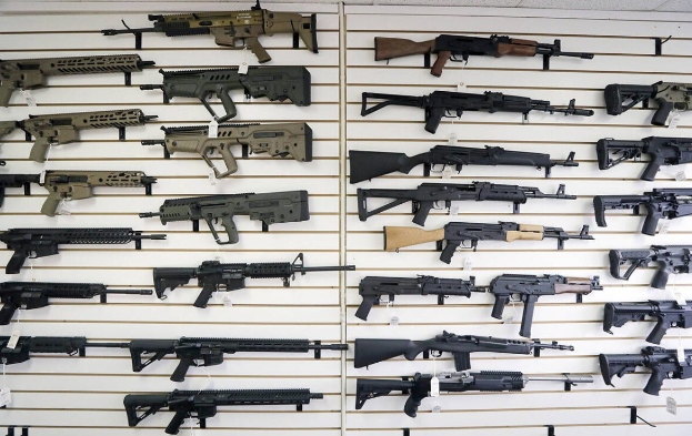Semi-automatic rifles fill a wall on Oct. 2, 2018, at a gun shop in Lynnwood, Washington.