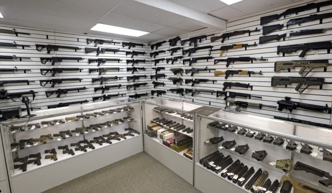 Dozens of semi-automatic rifles line a pair of walls in a gun shop in Lynnwood.