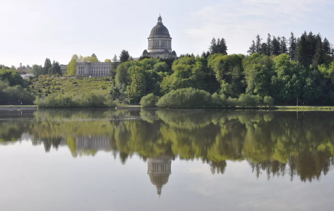 OLYMPIA – Washington's domed Legislative Building, finished in 1928, and the nearby Temple of Justice reflected in the Capitol Lake on a calm day.