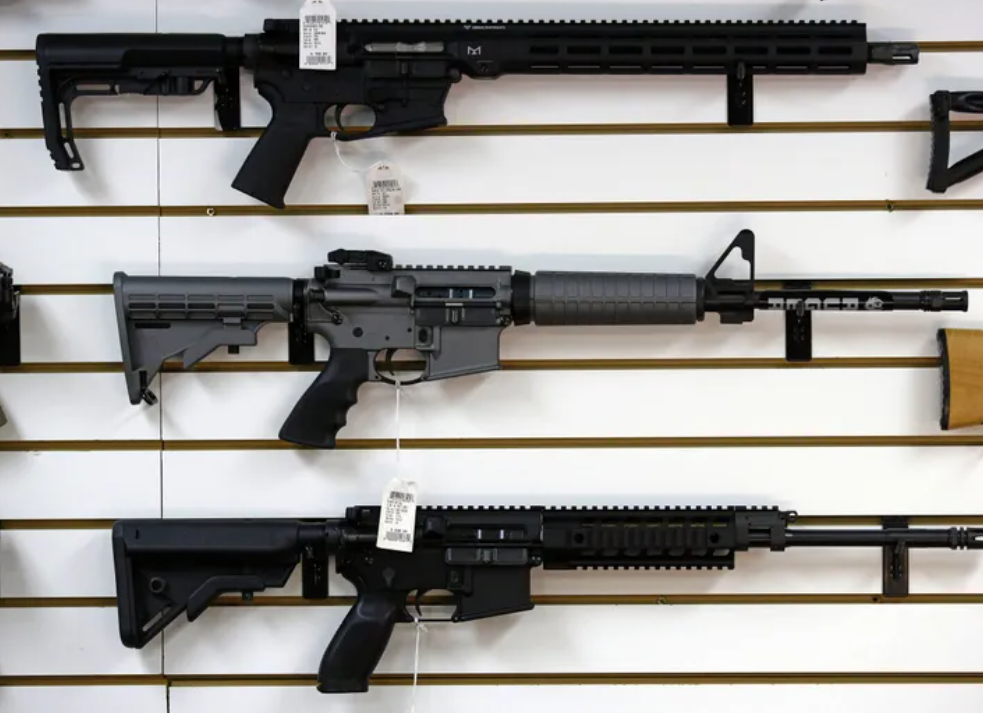 A Ruger AR-15 semiautomatic rifle, center, is on display with other rifles in a gun shop in Lynnwood.