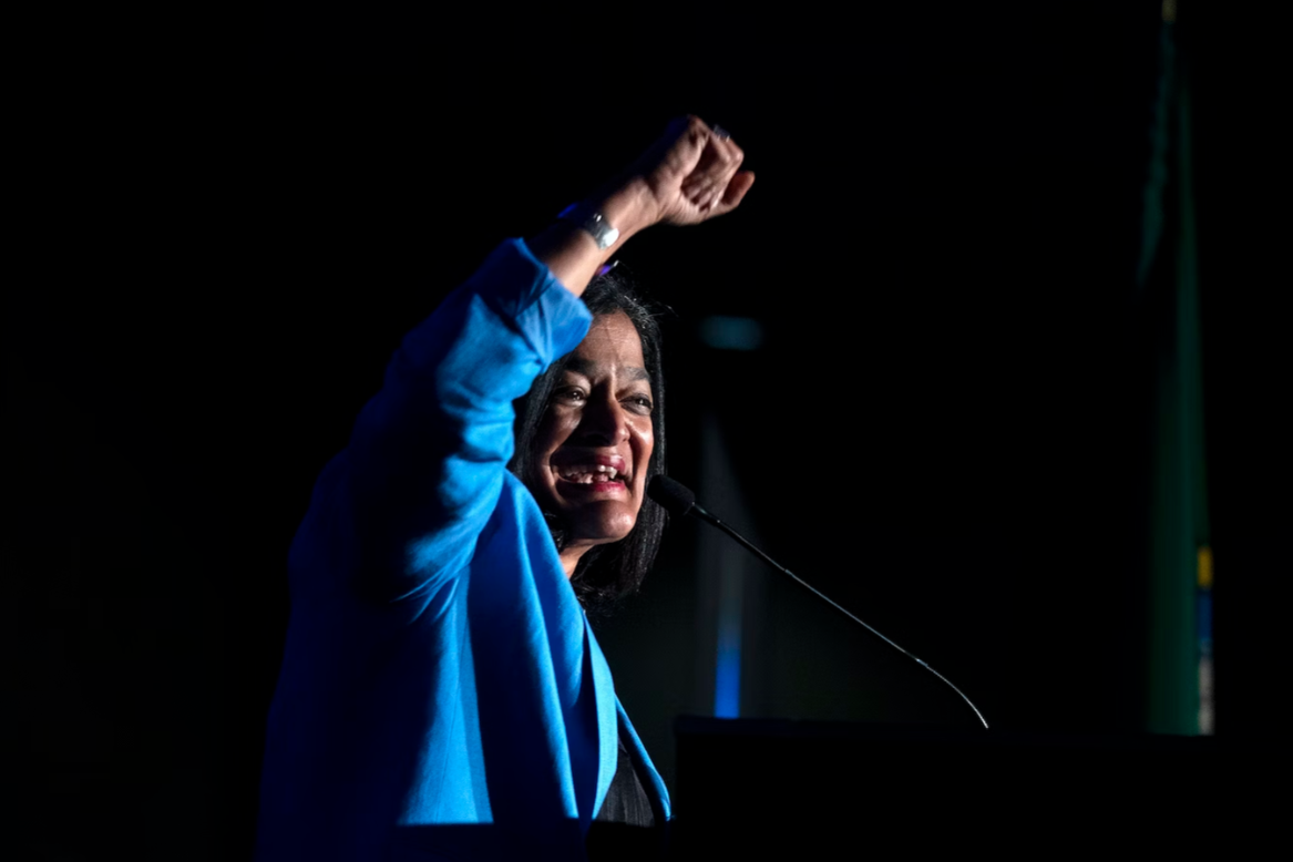 Congresswoman Pramila Jayapal raises a fist in the air while speaking to supporters on Tuesday, November 8, 2022, during an election night party at the Westin in Bellevue.