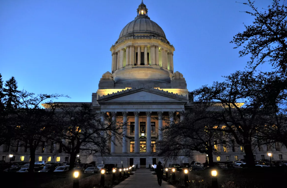 Lights come on in the domed Legislative Building on the Washington Capitol Campus as evening approaches in Olympia