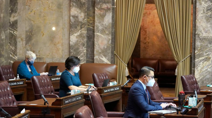 Senators Joe Nguyen, right, D-White Center, Emily Randall, center, D-Bremerton, and Karen Keiser, D-Des Moines, sit socially distanced in the Senate Chambers at the Capitol in Olympia in 2021.