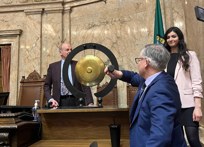 Rep. Bill Ramos, D-Issaquah, takes a swing at a gong, a less-than-conventional presence on the House of Representatives floor, after Democrat Tacoma Reps. Jake Fey and Sharlett Mena just took their turns Sunday.