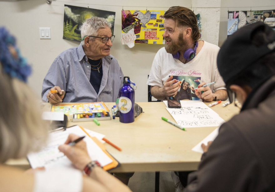Joseph Anderson, right, chats with Steve Manshour during Art Studio time at the Everett Recovery CaFE on Wednesday, May 10, 2023 in Everett, Washington.