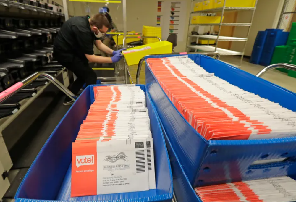 Vote-by-mail ballots are shown in sorting trays at the King County Elections headquarters in Renton on Aug. 5, 2020.