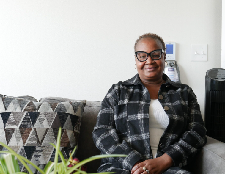 Tracy Williams sits in her Seattle apartment at George Fleming Place, which is funded in part by the state’s Housing Trust Fund. The fund saw record investment this year of $400 million.