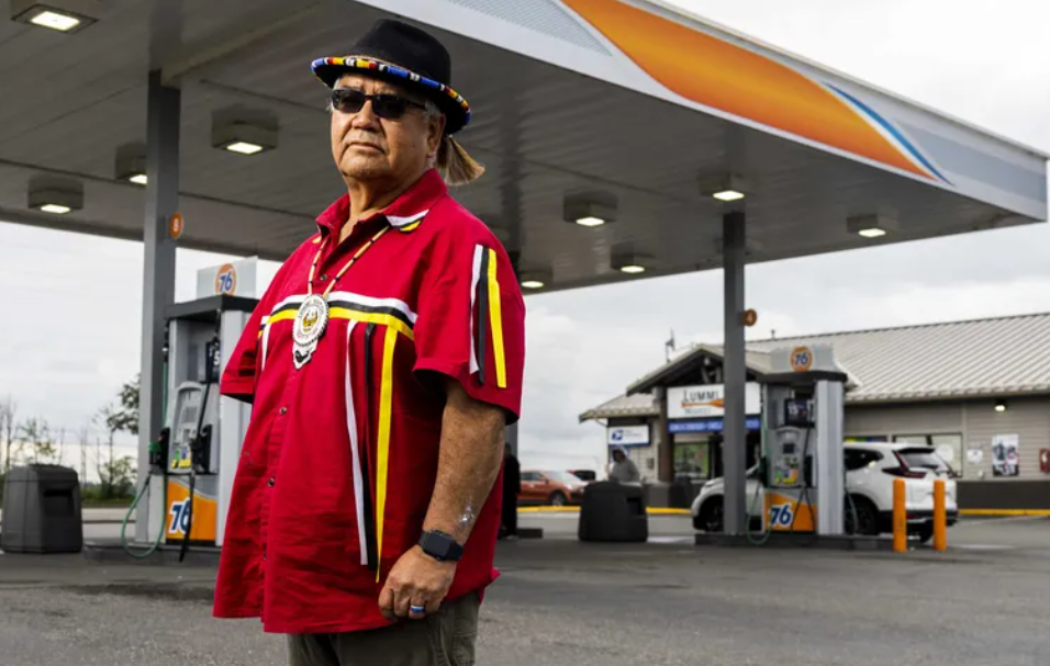 Henry Cagey, a member of the Lummi Nation Business Council, stands next to the Lummi Bay Market near the Silver Reef Casino Resort on the Lummi Reservation last month. Gov. Jay Inslee doesn’t think Washington should exempt tribal gas stations from climate laws.