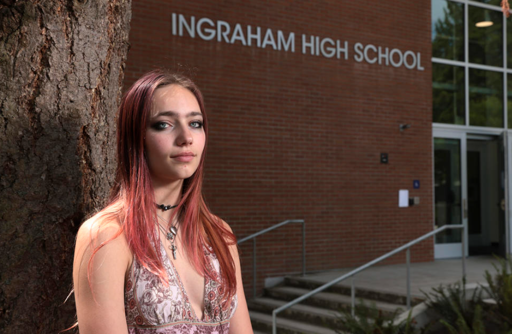 Seattle Student Union executive board member Noir Goldberg, 17, a junior at Ballard High School, is pictured outside Ingraham High School, where a student was shot and killed last fall, following a press conference announcing the launch of Reach Out Seattle.