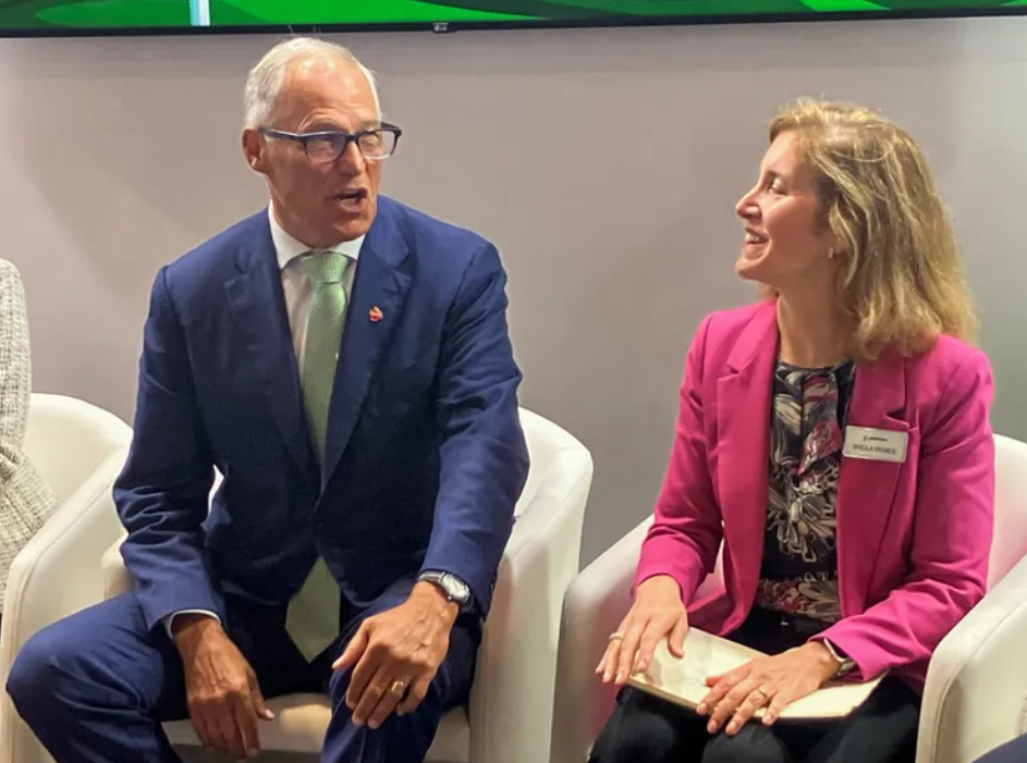 Gov. Jay Inslee speaks with Sheila Remes, Boeing vice president of environmental sustainability, as they prepare to speak at the Paris Air Show on a panel about aviation sustainability on June 20, 2023.