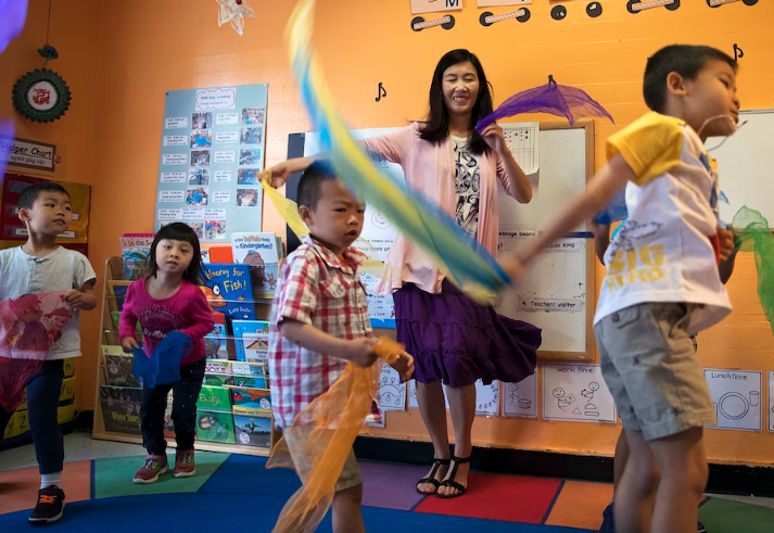 Seattle Preschool Program teacher Hien Do dances with her students on June 28, 2017, at the ReWA Beacon Hill Early Learning Center in Seattle.
