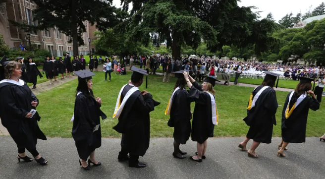 In 2016, graduates make last-minute preparations ahead of a Department of Communications ceremony at the University of Washington.
