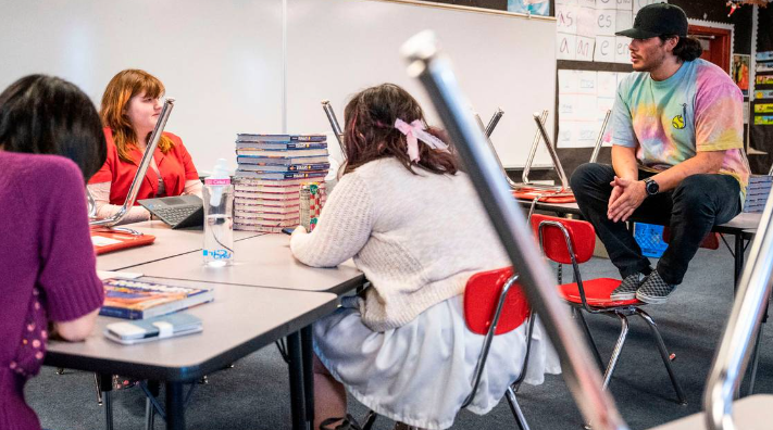 Orting High School Spanish teacher and culture club advisor Mauricio Portillo talks with a student during a culture club meeting in his classroom after school, on May 8, 2023. Portillo’s goal is to create a safe space for underrepresented students.