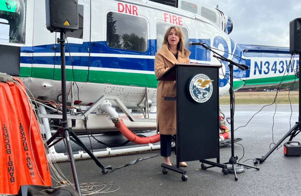 Commissioner of Public Lands Hilary Franz speaks to reporters at the Department of Natural Resources hanger at the Olympia Regional Airport. She recapped this year’s fire season, which had high fire starts but few acres burned.