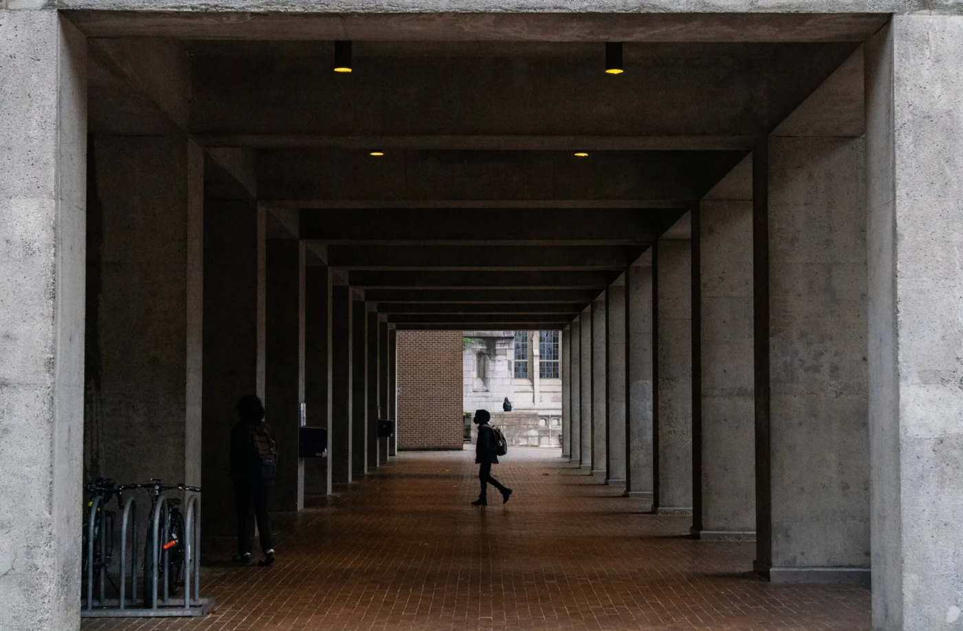 A student walks to UW’s Kane Hall on a gray and rainy day in November 2022