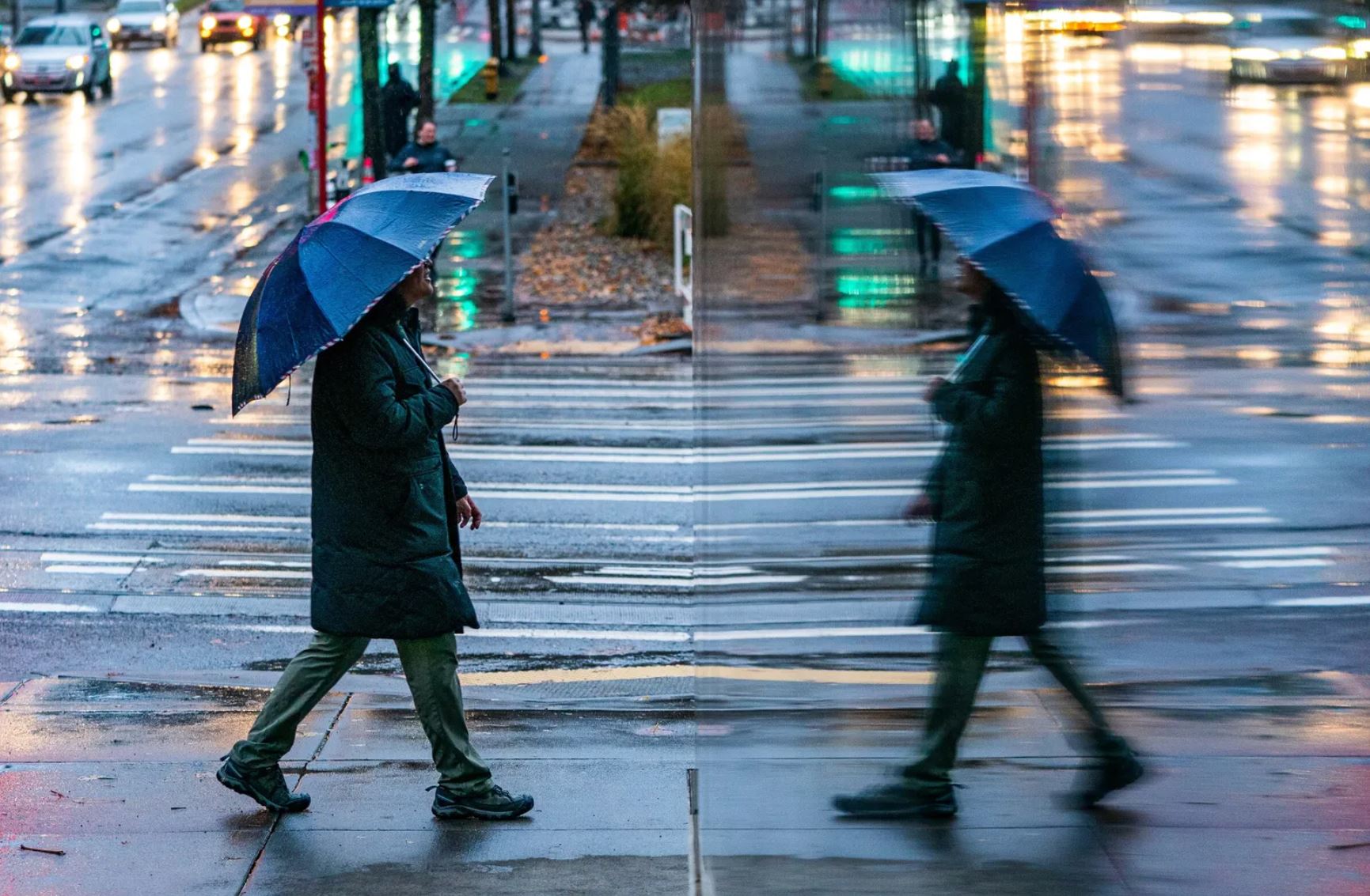 A pedestrian walks through South Lake Union on a rainy Sunday, Dec. 4, 2022.