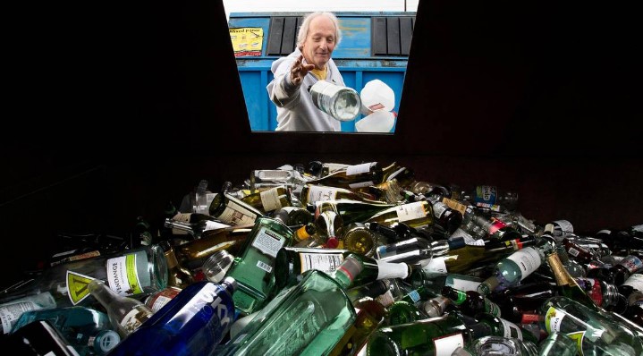Dennis DeMoor of Lacey drops off a wine bottle for glass recycling at the Thurston County Waste and Recovery Center in Lacey in 2019.