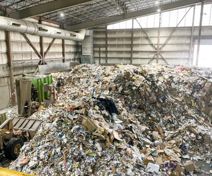  A mountain of recyclables rises from the tipping floor — where the trash is tipped — at the Recology materials recovery facility in Seattle.