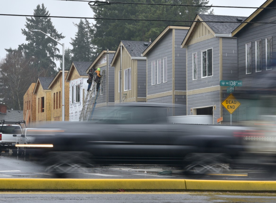 Cars pass in front of a construction site along Northeast 138th Avenue in east Vancouver. The local building industry is working with schools to funnel more young people into skilled trades professions.