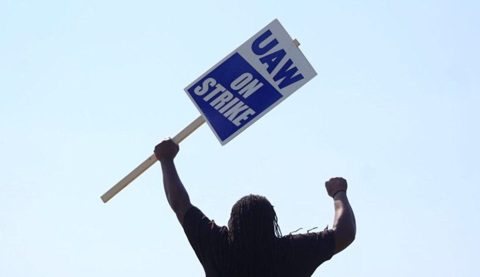  A UAW worker holds a strike sign.