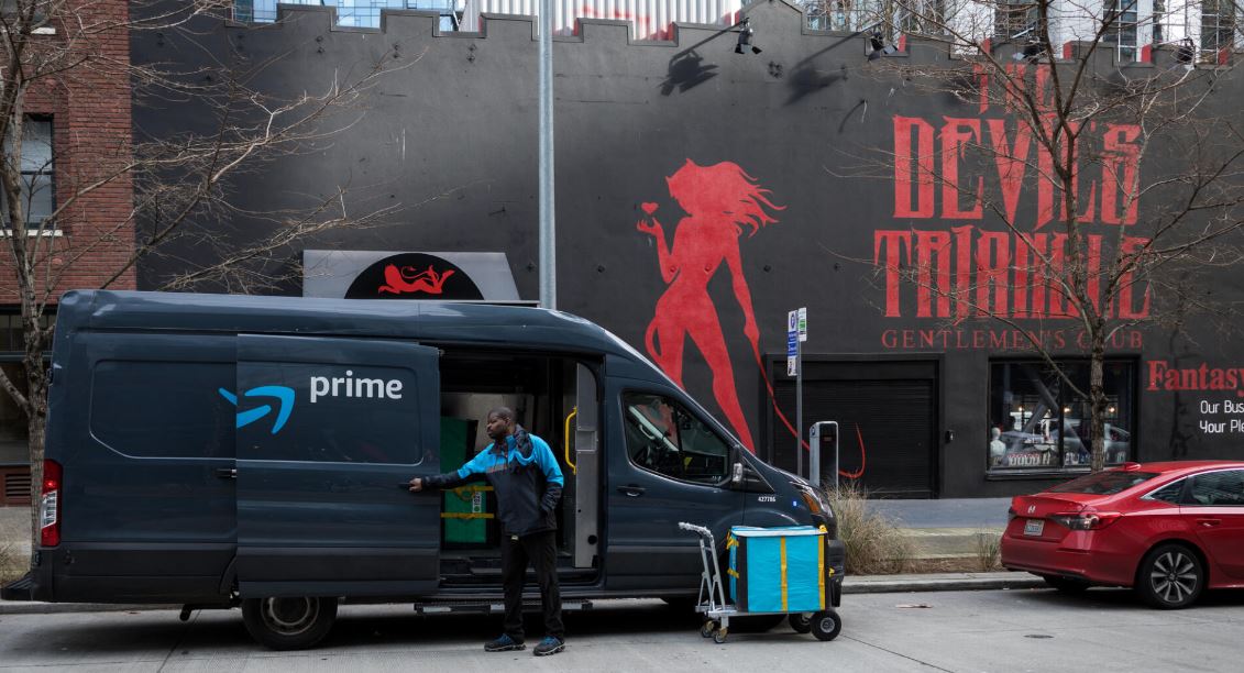 An Amazon prime delivery van parks Feb. 23, 2023, in front the Devil's Triangle near the Amazon Campus in South Lake Union, Seattle.