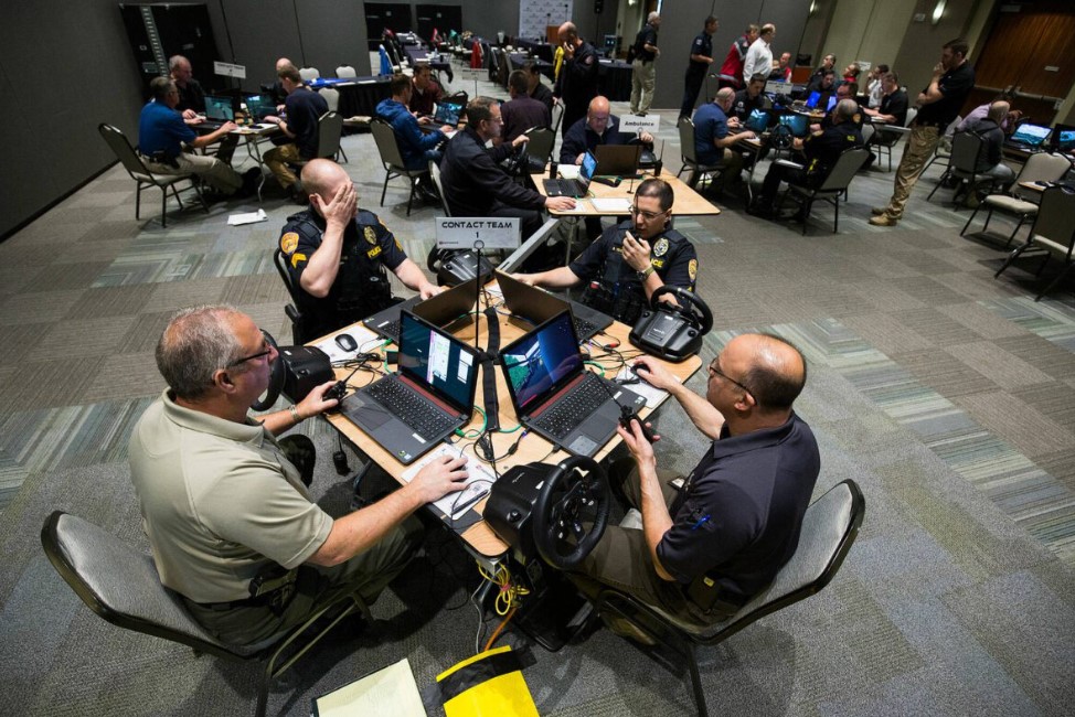 Law enforcement officers, firefighters and medics from Snohomish, King and Pierce counties use computers to simulate an active shooter scenario in a ballroom at Angel of the Winds Arena on Wednesday, June 13, 2018 in Everett, Wa